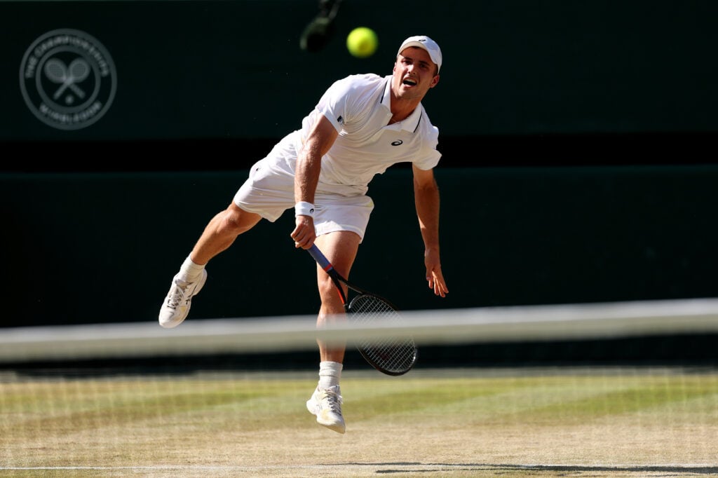 Arthur Fery of Great Britain serves against Flavio Cobolli of Italy during their Gentlemen's Singles quarterfinal match on day ten of The Championships Wimbledon 2026 at All England Lawn Tennis and Croquet Club on July 08, 2026 in London, England.