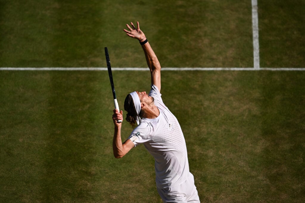 Alexander Zverev hits a serve during his Wimbledon quarter-final win over Taylor Fritz.