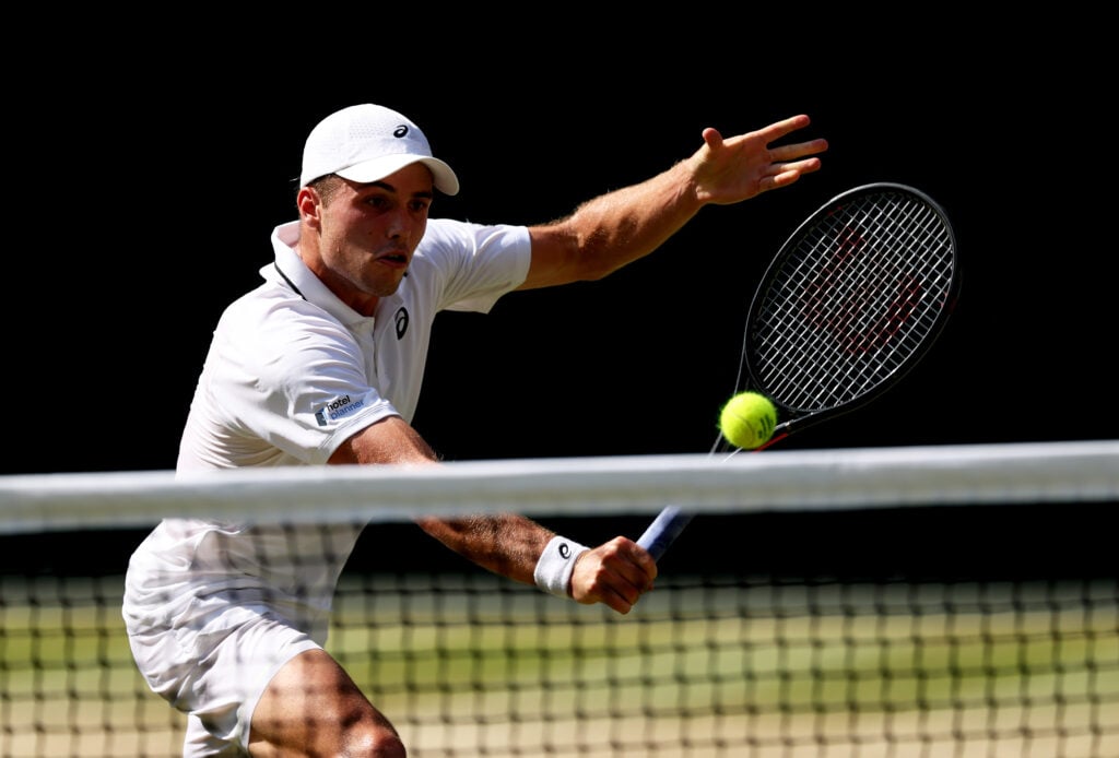 Arthur Fery of Great Britain plays a backhand volley against Flavio Cobolli of Italy during their Gentlemen's Singles quarterfinal match on day ten of The Championships Wimbledon 2026 at All England Lawn Tennis and Croquet Club on July 08, 2026 in London, England.