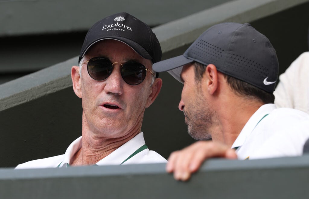 Jannik Sinner of Italy's coach, Darren Cahill, in his player box talks with another team member during the Gentlemen's Singles semifinal match against Novak Djokovic of Serbia on day twelve of The Championships Wimbledon 2026 at All England Lawn Tennis and Croquet Club on July 10, 2026 in London, England.
