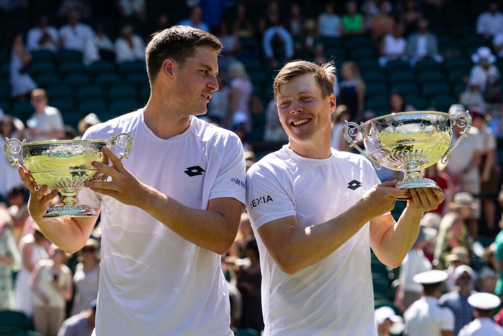 Henry Patten and Harri Heliovaara pose with the Wimbledon trophies in 2026.