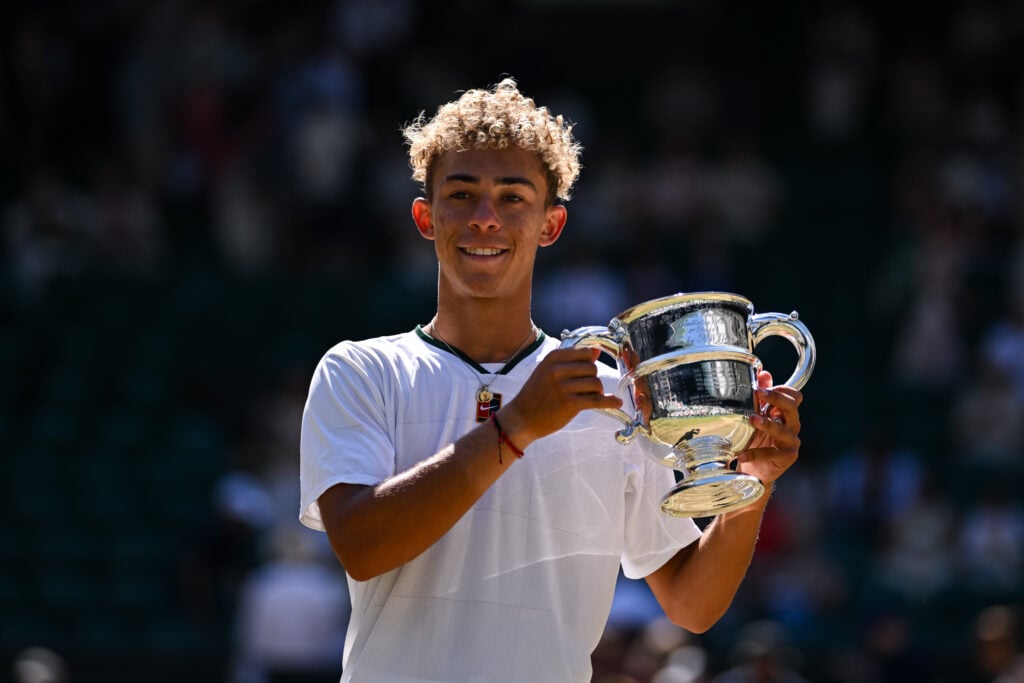 Jordan Lee poses with the trophy after winning the junior Wimbledon event in 2026.