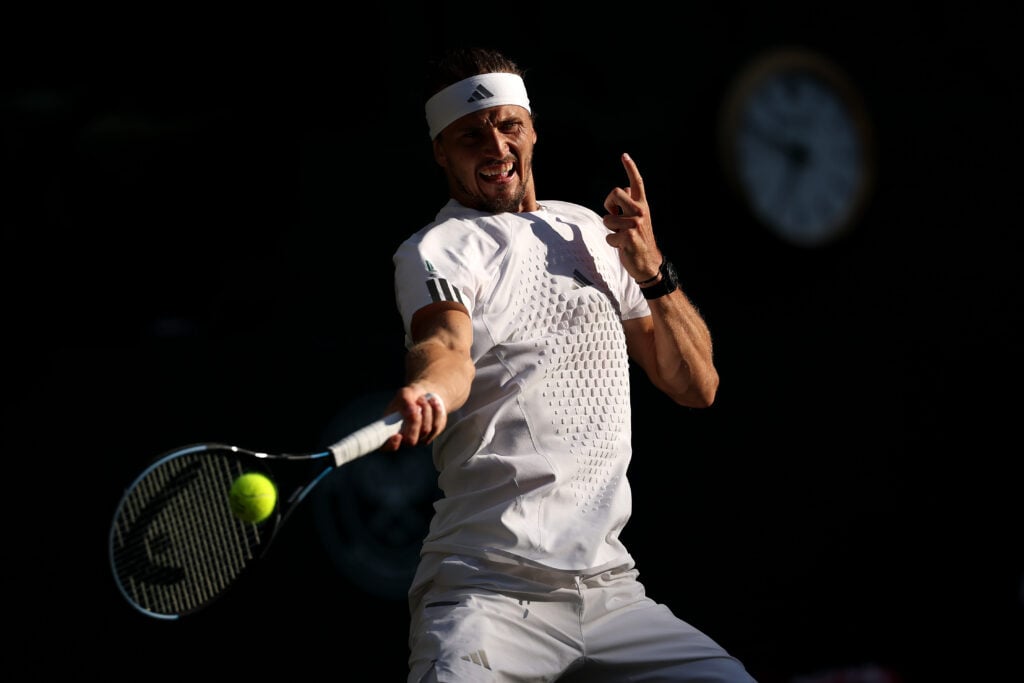 Alexander Zverev of Germany plays a forehand against Jannik Sinner of Italy during their Gentlemen's Singles final match on day fourteen of The Championships Wimbledon 2026 at All England Lawn Tennis and Croquet Club on July 12, 2026 in London, England.
