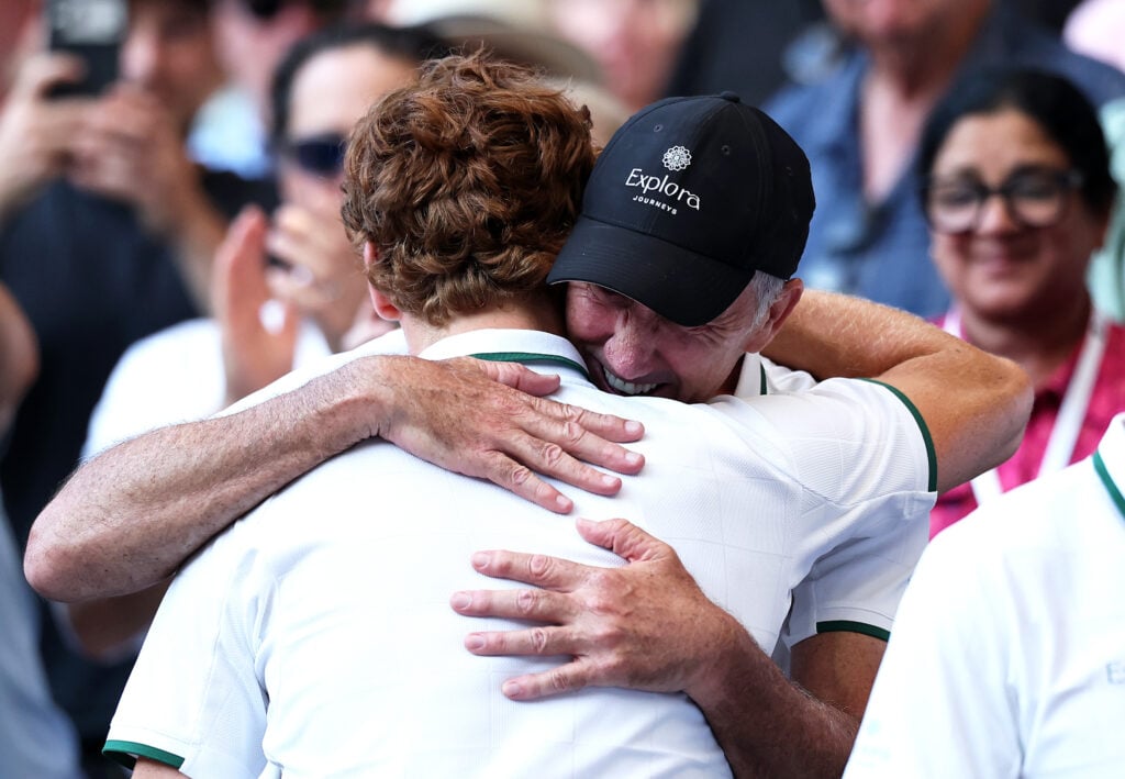 Jannik Sinner of Italy climbs into the stands and hugs his coach Darren Cahill after victory against Alexander Zverev of Germany during their Gentlemen's Singles final match on day fourteen of The Championships Wimbledon 2026 at All England Lawn Tennis and Croquet Club on July 12, 2026 in London, England.