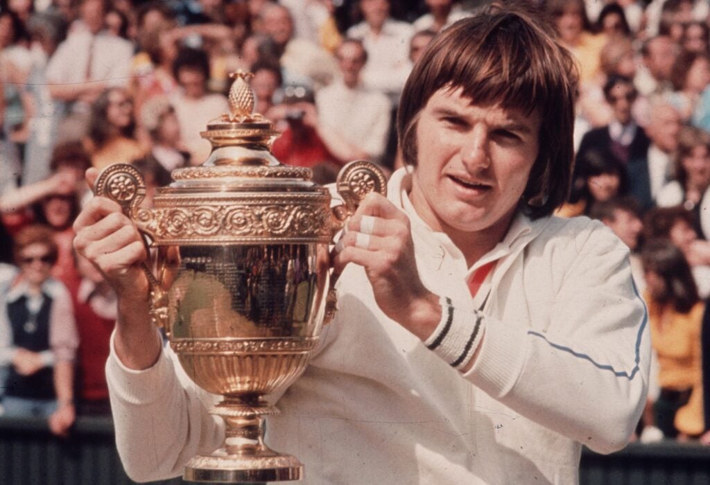 1974: American tennis player Jimmy Connors, holding his trophy after winning the Men's Singles Final at Wimbledon.
