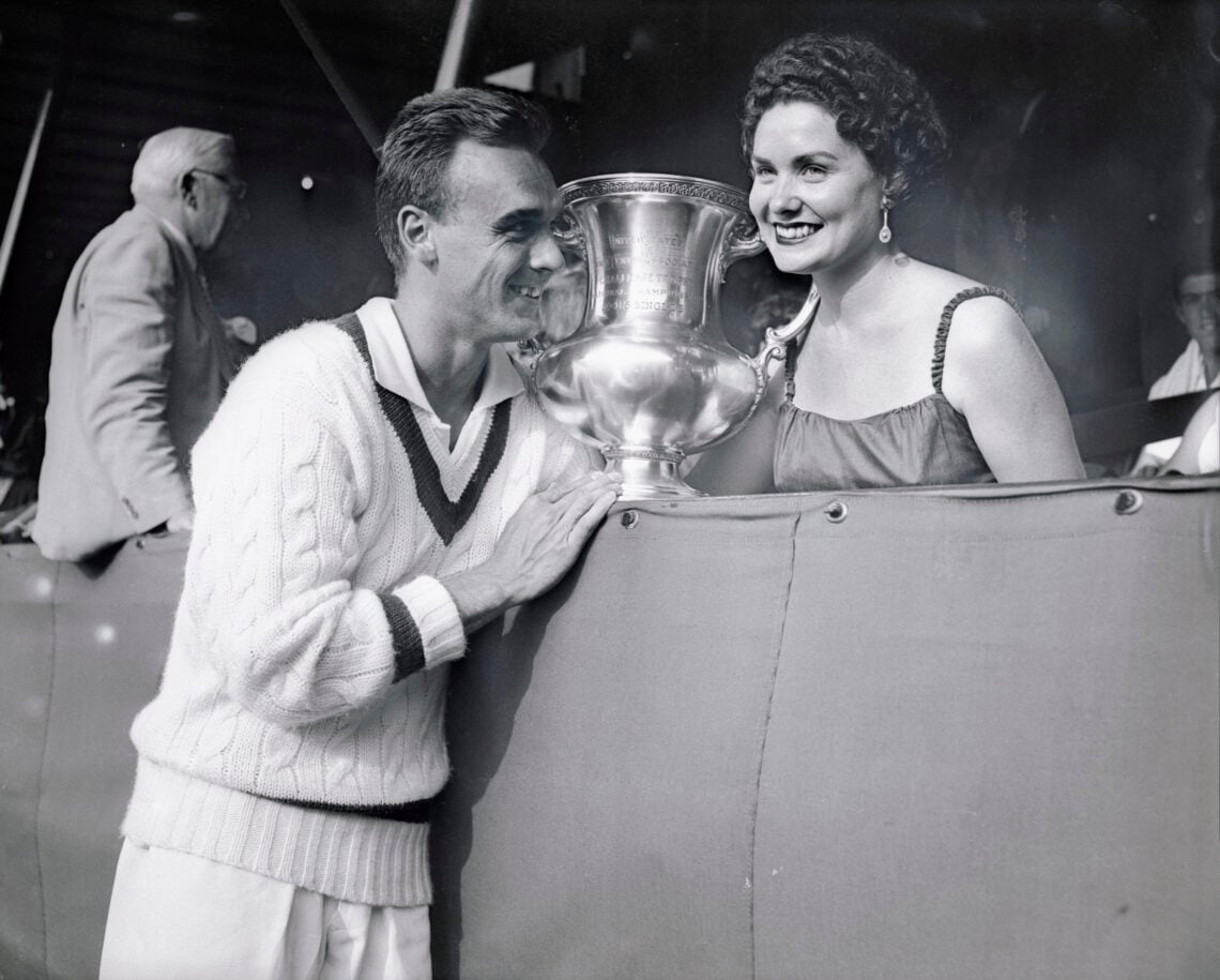 (Original Caption) Vic Seixas, 1953 Wimbledon champ, is shown with his wife and trophy after winning the U.S. Amateur Tennis Crown today. Going to ...