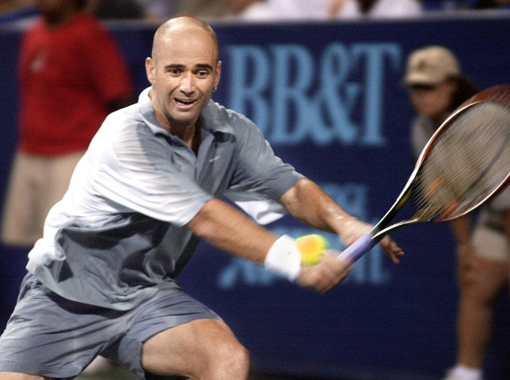 Andre Agassi of the US returns a shot against Sjeng Schalken of the Netherlands during their semi-final Legg Mason Tennis Classic match 18 August 2001 in Washington, DC.