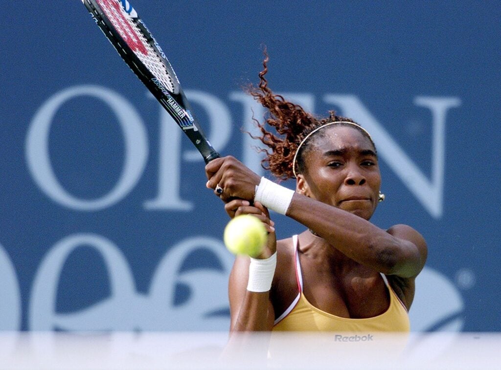 Venus Williams of the US follows through in a backhand stroke during her semi-finals match against Martina Hingis of Switzerland, 08 September 2000, at the US Open Tennis Tournament in Flushing Meadows, NY. The winner will play Lindsay Davenport of the US in the final.