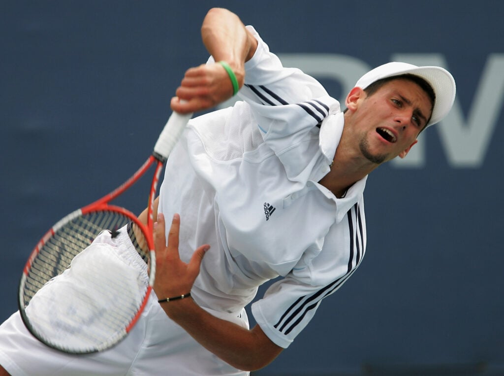 Novak Djokovic of Serbia hits to Gael Monfils of France returns during the first round of the US Open at the USTA National Tennis Center in Flushing Meadows Corona Park on August 30, 2005 in the Flushing neighborhood of the Queens borough of New York City.