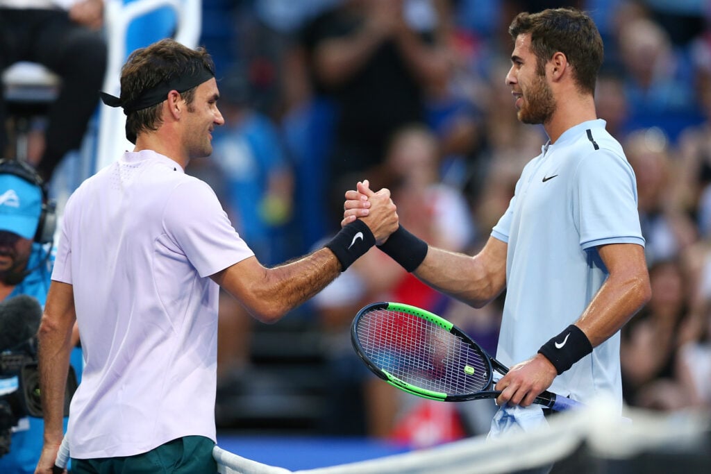 Roger Federer and Karen Khachanov embrace at the 2018 Hopman Cup.