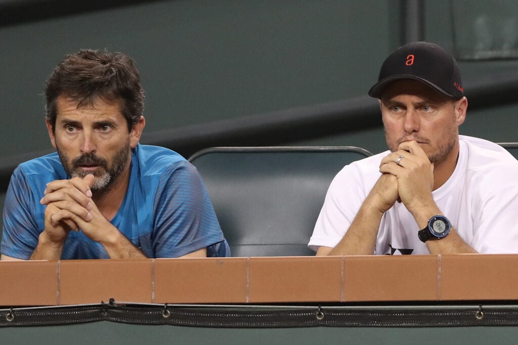Adolfo Gutierrez and Lleyton Hewitt watch Alex De Minaur of Australia play Juan Martin Del Potro of Argentina during the BNP Paribas Open at the Indian Wells in 2018.
