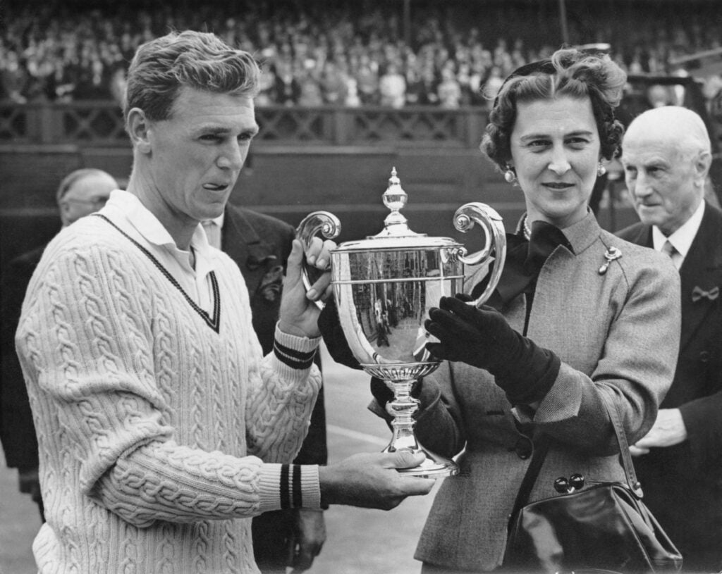 Australian tennis player Frank Sedgman receives a cup from the Duchess of Kent (1906 - 1968) after beating Jaroslav Drobny on the Centre Court at Wimbledon, to win the Men's Singles title, 4th July 1952. He is the first Australian to do so since World War II.
